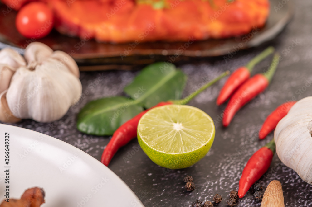 lime Chili peppers and garlic on cement. lime Chili peppers and garlic on cement.