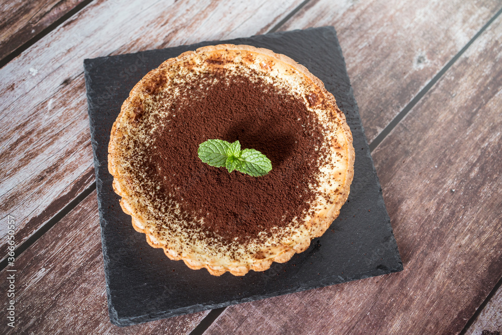 A top view of a delicious chocolate tart with mint on top