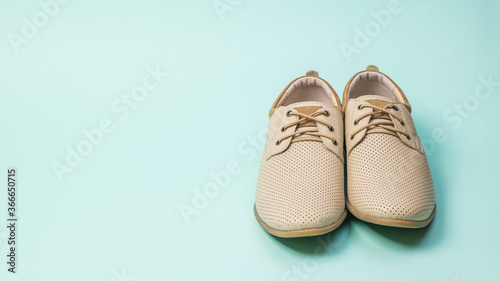 Front view of summer men's shoes on a blue background.
