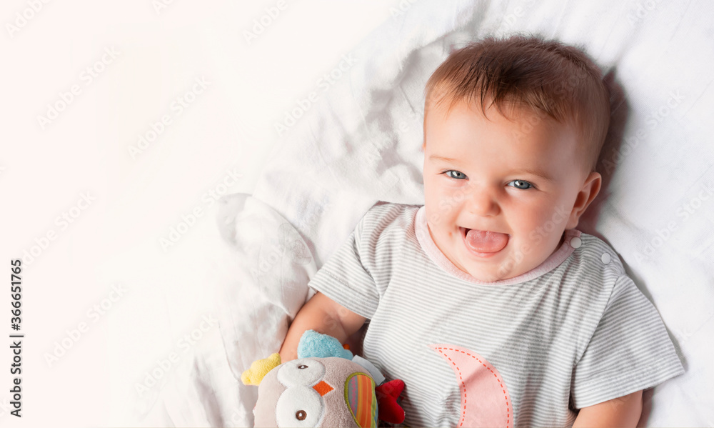 happy baby smiling playing with a toy on a white background happy baby smiling playing with a toy on a white background
