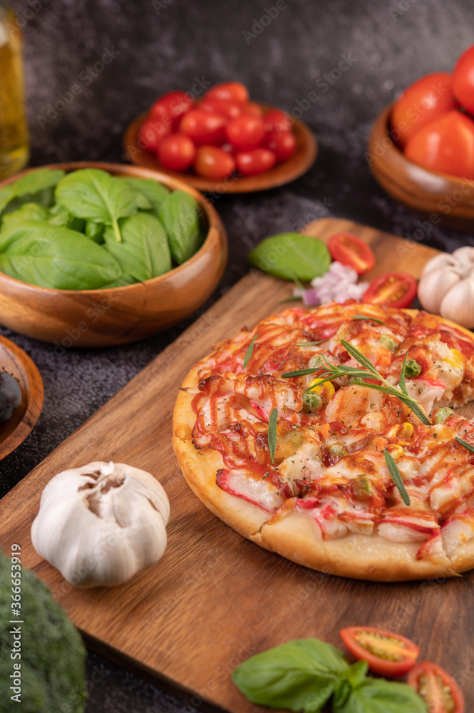pizza placed on a wooden plate. pizza placed on a wooden plate.