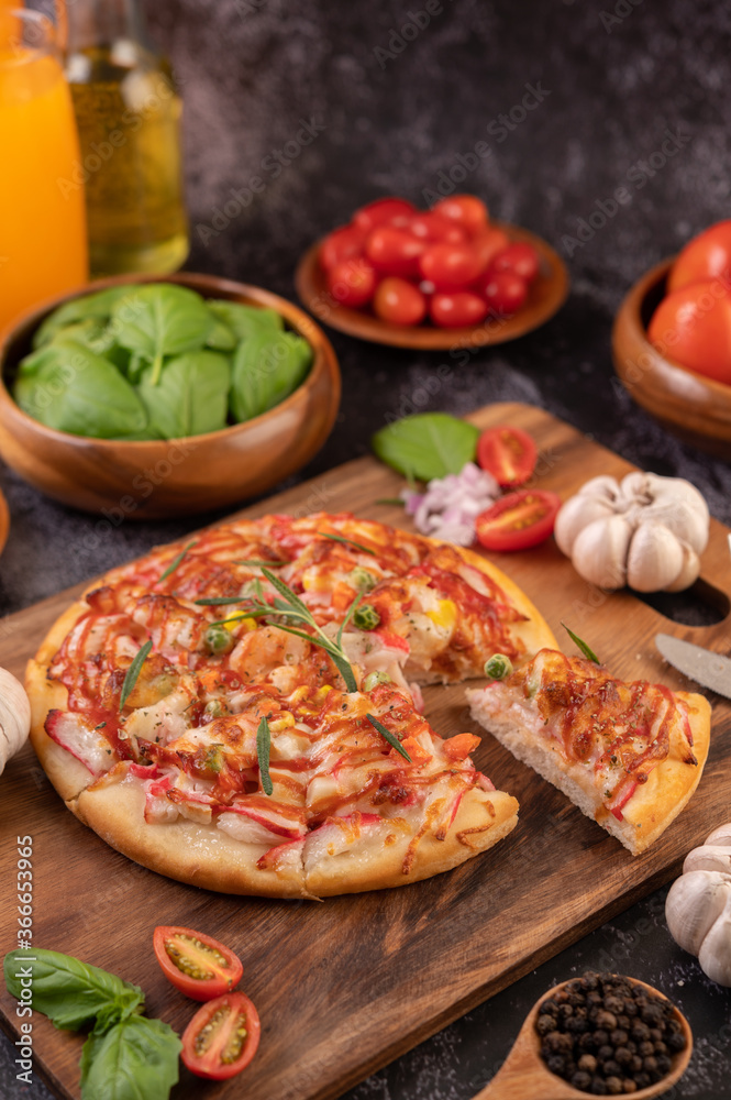 pizza placed on a wooden plate. pizza placed on a wooden plate.