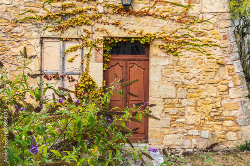 Europe, France, Dordogne, Hautefort. Brown door in a stone house in the town of Hautefort. © Emily_M_Wilson
