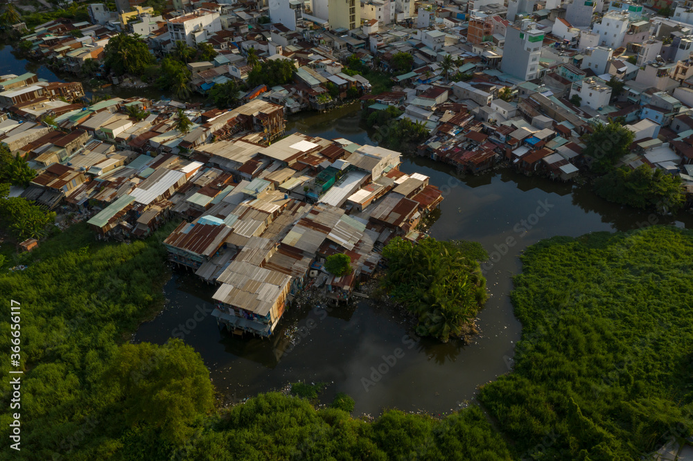 interesting old residential and business area of Saigon, Vietnam resembling a crowded shanty town built along a canal from aerial top down view