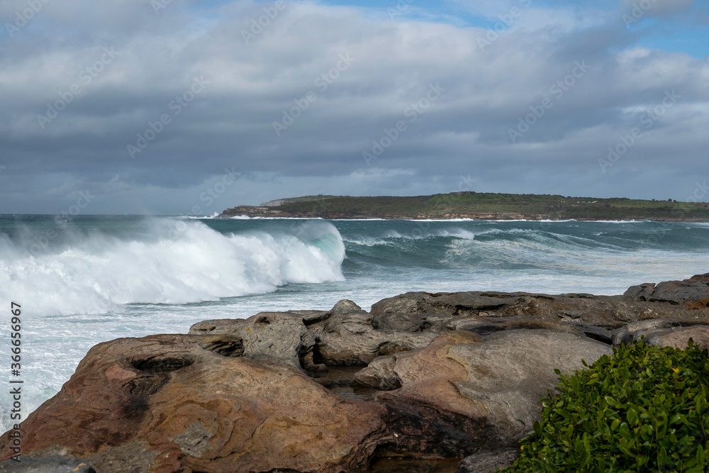 Fototapeta premium Beautiful big splashing blue wave, after a big storm