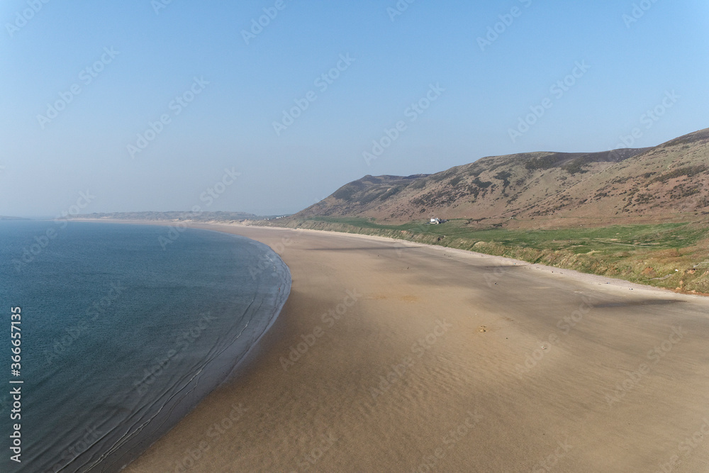 Rhossili beach, Gower peninsula, Wales UK, Blue sky beautiful scenic view, welsh coastline