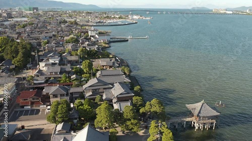 Lake Biwa and Ukimido temple, Aerial rise shot, Japan photo