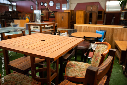 Wooden tables, chairs and other furniture offered for sale in store