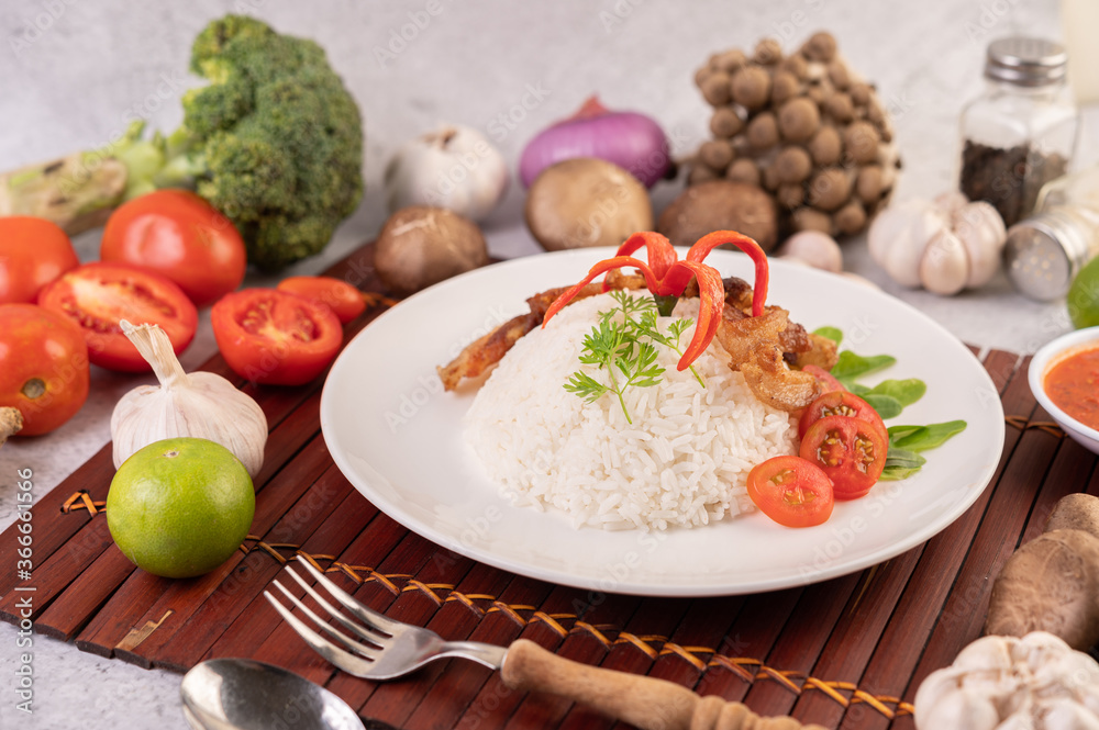 Pork belly fried on steamed rice on a plate. Pork belly fried on steamed rice on a plate.