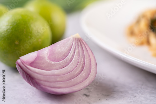 Cut onions in half and lime on cement floor