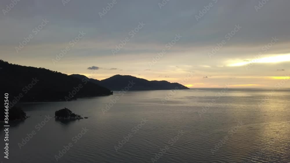 Aerial view dramatic sunset hour at Batu Ferringhi sea. Back is Teluk Bahang forest. Aerial view dramatic sunset hour at Batu Ferringhi sea. Back is Teluk Bahang forest.
