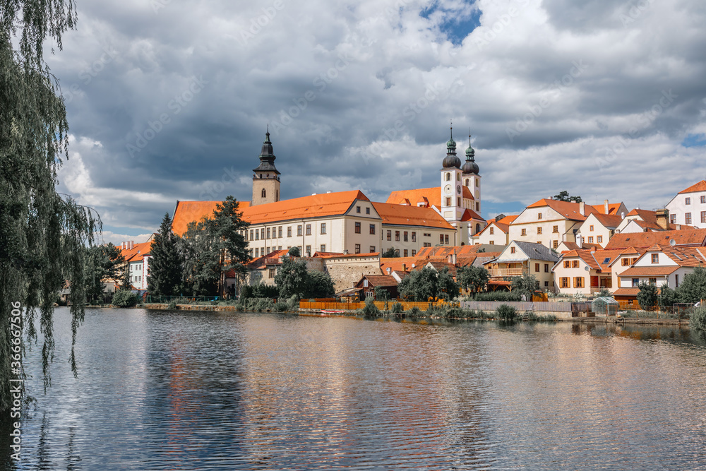 Telc city with dramatic sky. Water reflection of houses and Telc Castle, Czech Republic. UNESCO World Heritage Site. Telc city with dramatic sky. Water reflection of houses and Telc Castle, Czech Republic. UNESCO World Heritage Site.