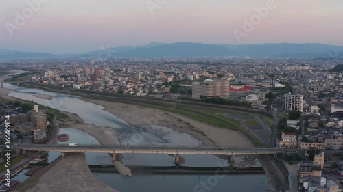 Gifu city and Nagaragawa river, Truck driving across bridge as sun rises photo