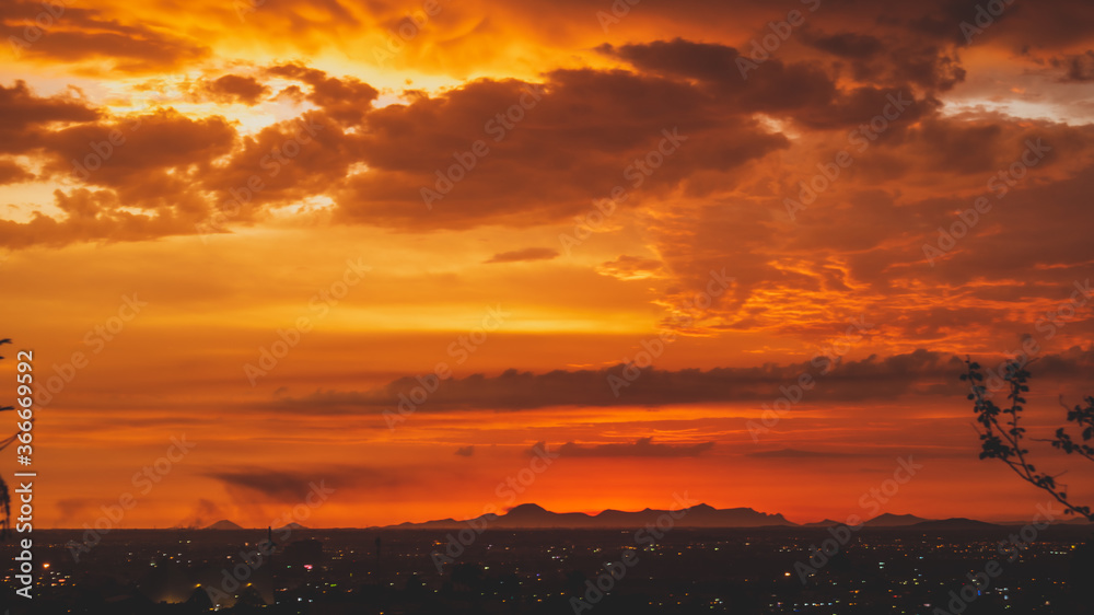beautiful sunset with cloudy skies over the city and mountains 