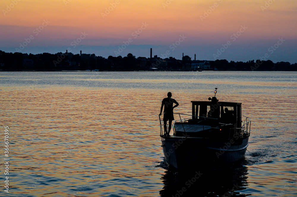 silhouette of a fishing boat at sunset