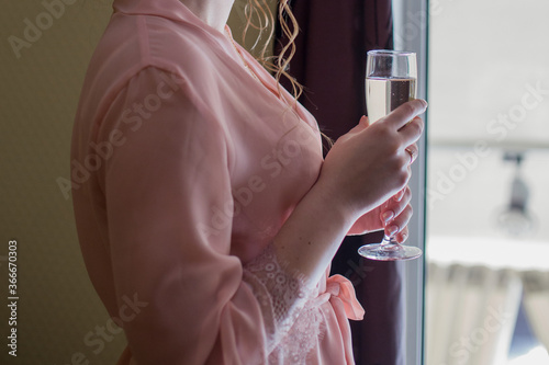 girl in a peignoir and a glass of champagne