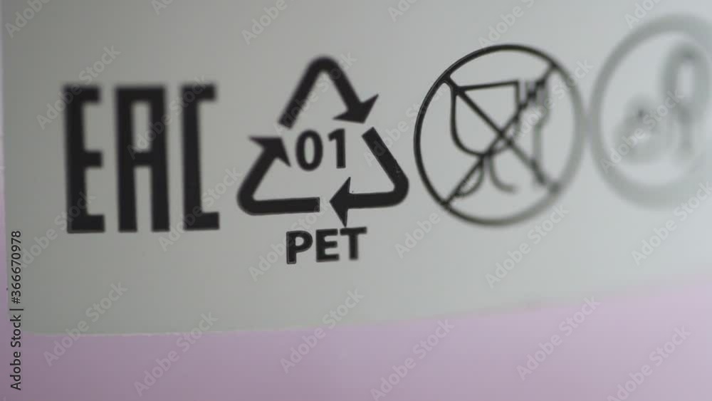 Macro view of eco labeling and recycling marks on product packaging spbd. Moving shot of symbols and letters on white background. Figure helps to understand what kind of packaging it is and whether it Macro view of eco labeling and recycling marks on product packaging spbd. Moving shot of symbols and letters on white background. Figure helps to understand what kind of packaging it is and whether it