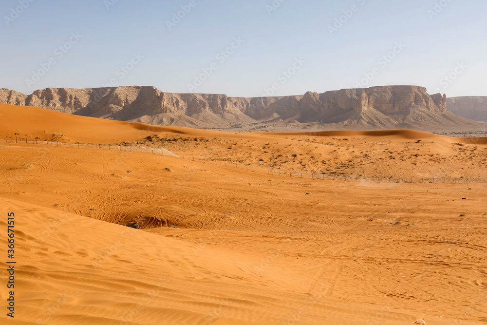 Red sand dunes called Red Sands south of Riyadh. You can see the lanes of quads because the dunes are a popular destination for people to drive around in the dunes. Red sand dunes called Red Sands south of Riyadh. You can see the lanes of quads because the dunes are a popular destination for people to drive around in the dunes.