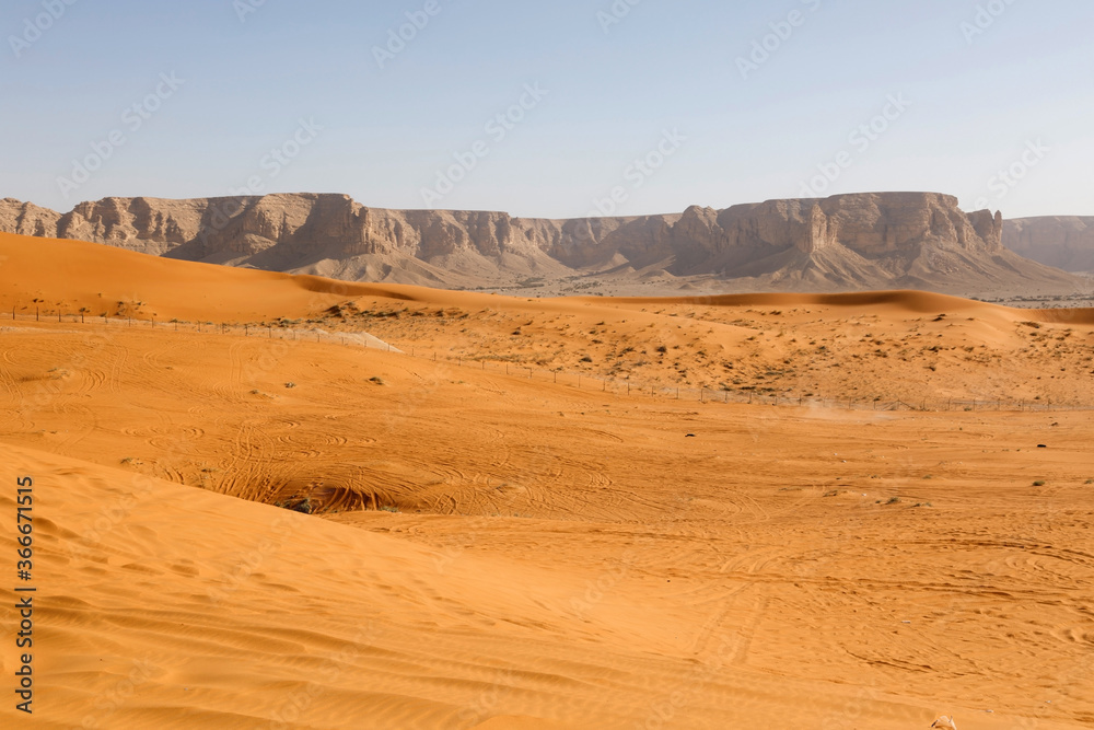 Red sand dunes called Red Sands south of Riyadh. You can see the lanes of quads because the dunes are a popular destination for people to drive around in the dunes.