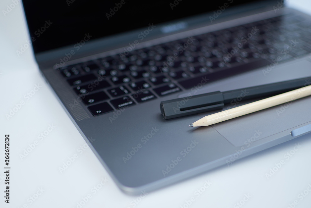 Close-up computer laptop keyboard, pen and pencil Close-up computer laptop keyboard, pen and pencil