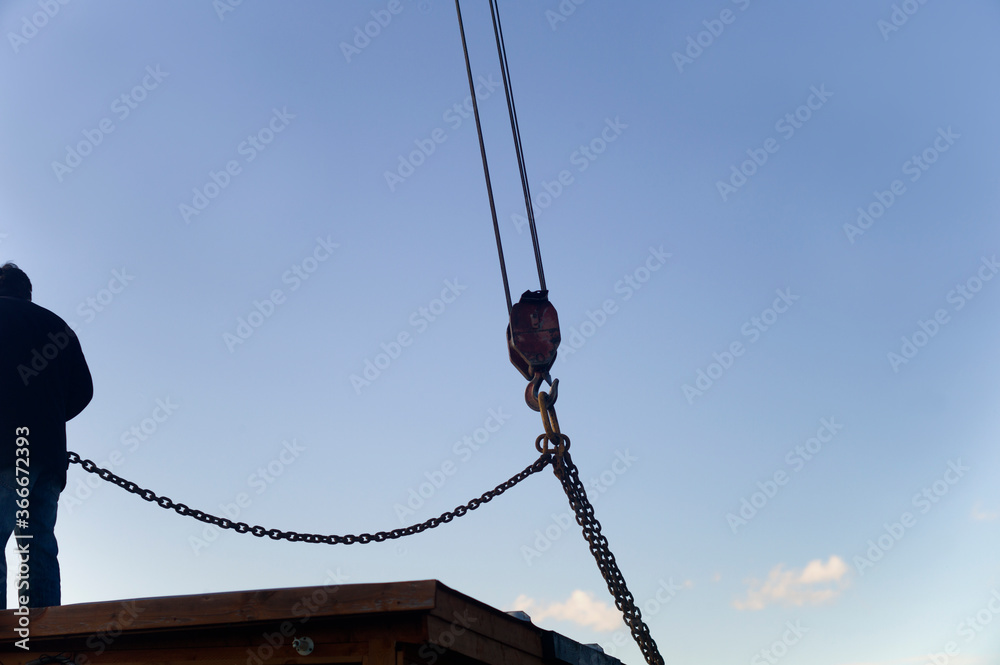 Fototapeta premium Lifting a house with crane