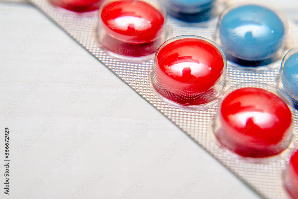 A package of red and blue tablets is placed on a white background
A package of red and blue tablets is placed on a white background