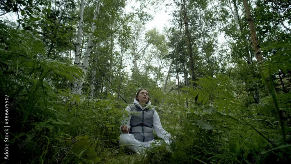 girl sitting in forest and meditating girl sitting in forest and meditating
