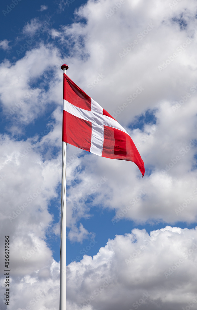 Danish flag with blue sky and clouds