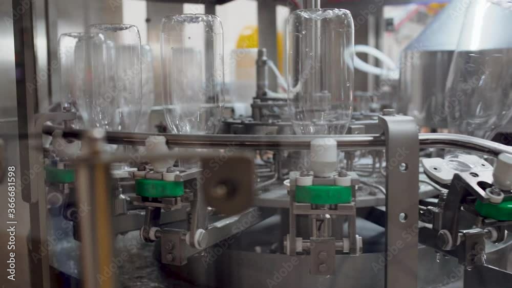 The new plastic bottles on the conveyor belt at the factory The new plastic bottles on the conveyor belt at the factory