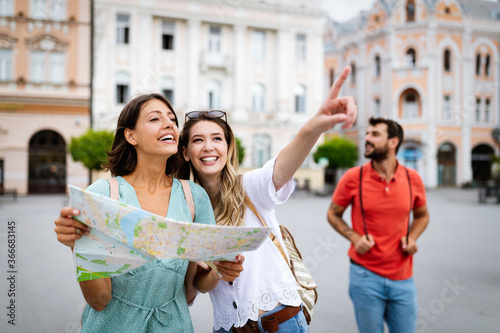 Happy traveling tourists sightseeing with map in hand © NDABCREATIVITY