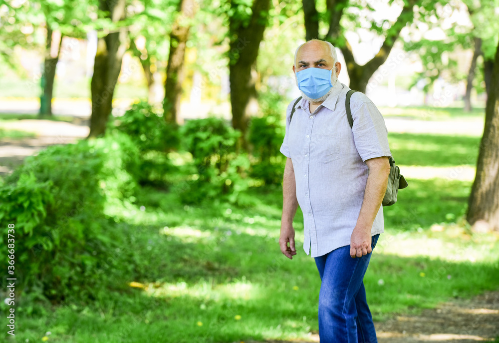 Pandemic concept. Limit risk infection spreading. Senior man face mask. Easing of lockdown restrictions. Wear mask. Quarantine extended. Mask protecting from virus. Older people highest risk covid-19 Pandemic concept. Limit risk infection spreading. Senior man face mask. Easing of lockdown restrictions. Wear mask. Quarantine extended. Mask protecting from virus. Older people highest risk covid-19