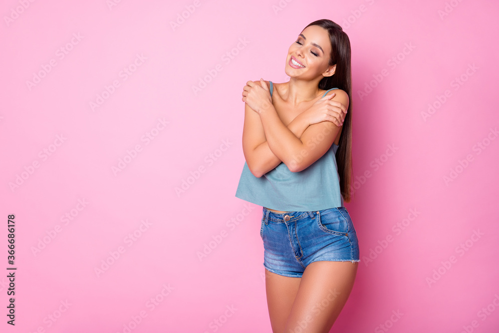 Portrait of charming candid content girl hug herself enjoy spring free time rest relax wear good look tank-top isolated over pastel color background Portrait of charming candid content girl hug herself enjoy spring free time rest relax wear good look tank-top isolated over pastel color background