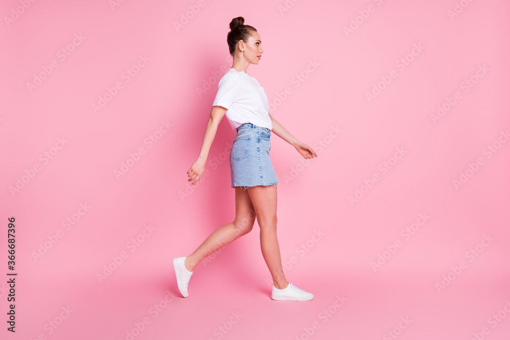 Full length profile side photo of minded serious lovely girl go walk copyspace wear casual style outfit isolated over pink color background Full length profile side photo of minded serious lovely girl go walk copyspace wear casual style outfit isolated over pink color background