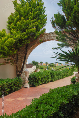 Tile path through the arch from the garden to the sea