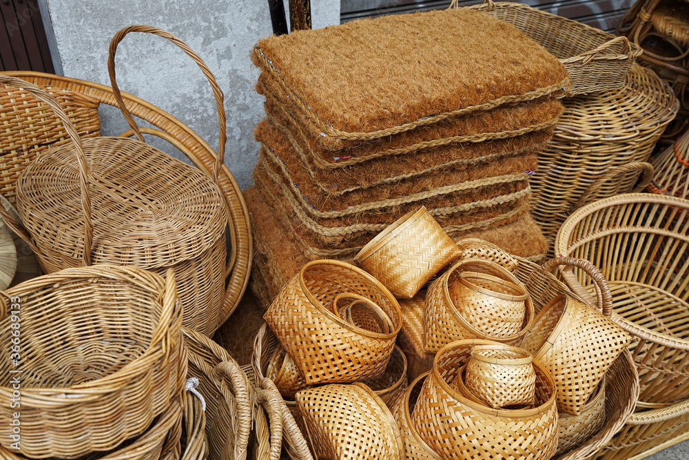 Rows and stacks of rattan weaving materials and furniture displayed on handmade craft store- Chiang mai, Thailand