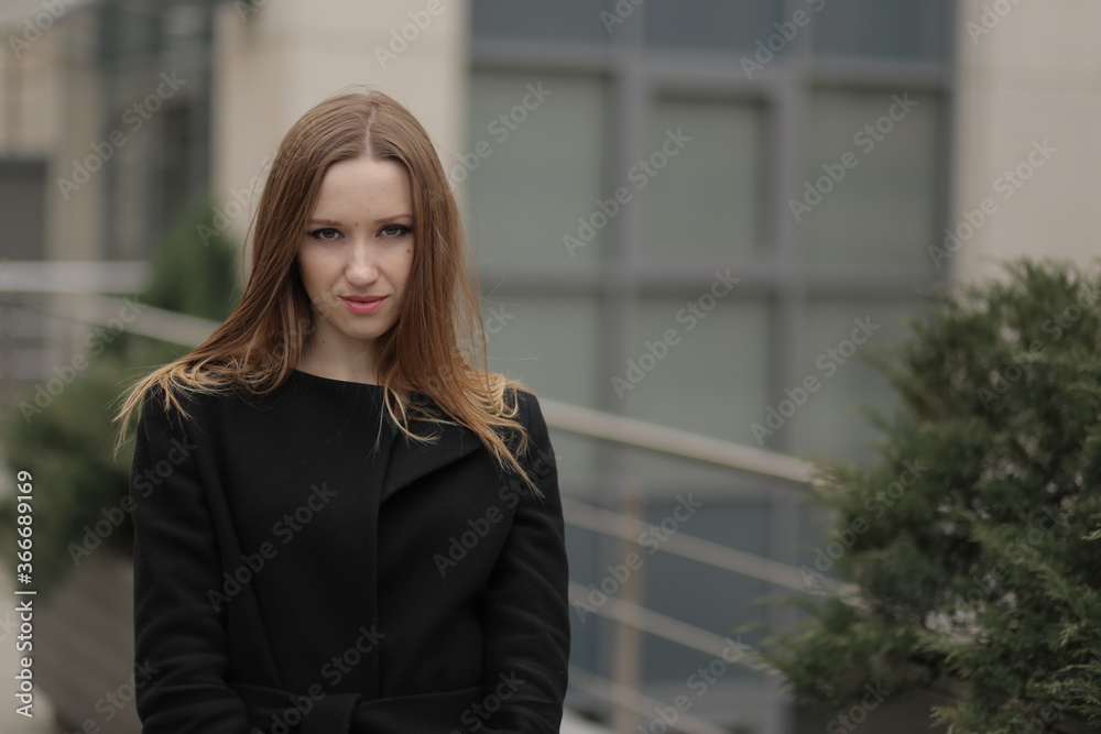 The girl in black coat. Beautiful emotional young girl in the city. Shawl or handkerchief on a person. The girl in black coat. Beautiful emotional young girl in the city. Shawl or handkerchief on a person.