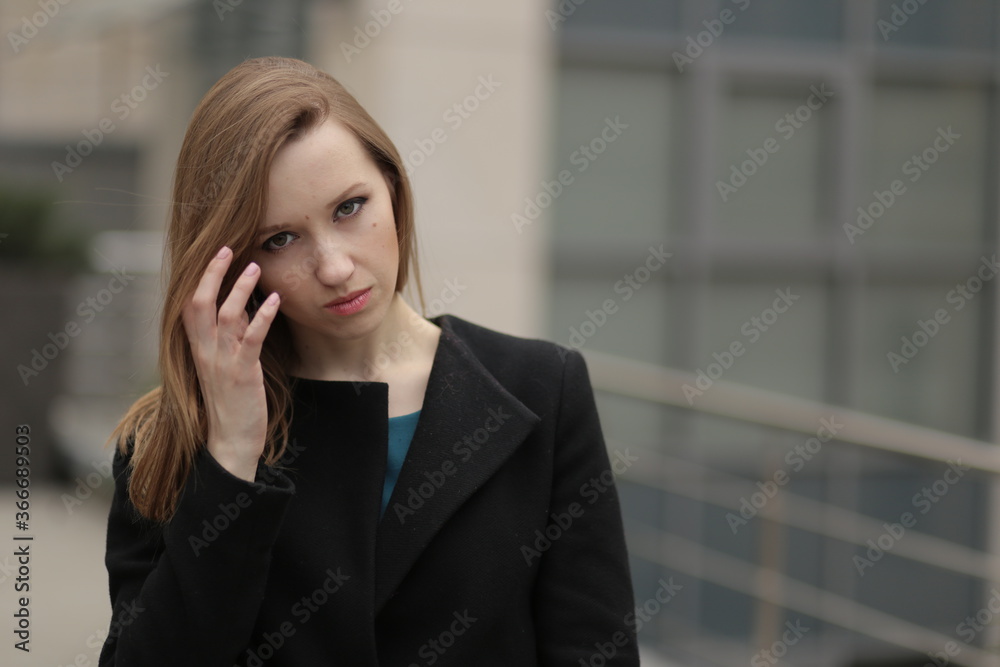 The girl in black coat. Beautiful emotional young girl in the city. Shawl or handkerchief on a person. The girl in black coat. Beautiful emotional young girl in the city. Shawl or handkerchief on a person.