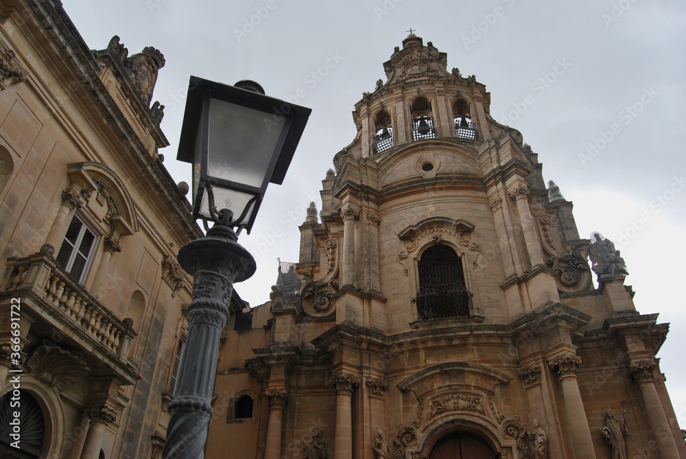 
baroque church facade with lamppost in the foreground