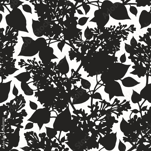 Spectacular black and white botanical print. Abstract seamless pattern with silhouettes of lilac flowers and leaves.