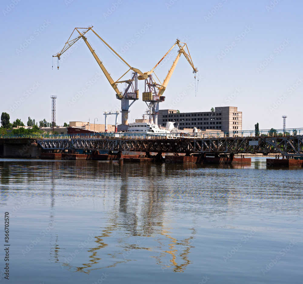 Yellow shipbuilding crane over water