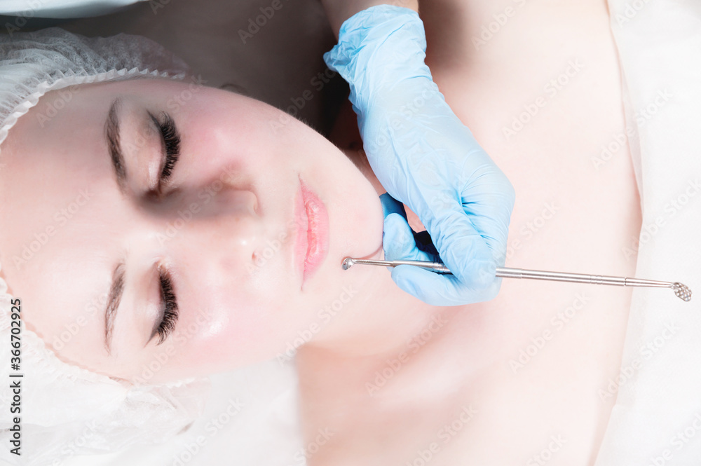 cosmetology and facials. Mechanical removal of the cleaning of an adult woman's face in the cosmetics office is a special tool. The concept of timely facial care cosmetology and facials. Mechanical removal of the cleaning of an adult woman's face in the cosmetics office is a special tool. The concept of timely facial care