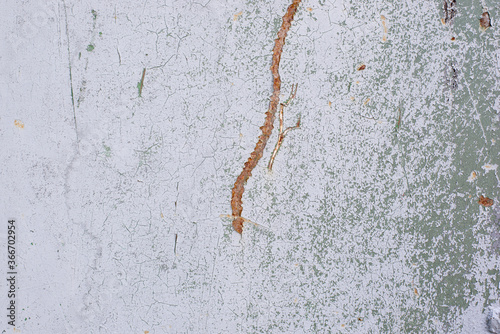 A lot of cracks on an old painted wall. Abstract grunge background