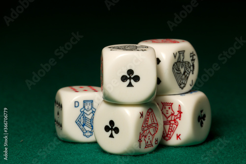 Playing poker dice straight closeup on green background