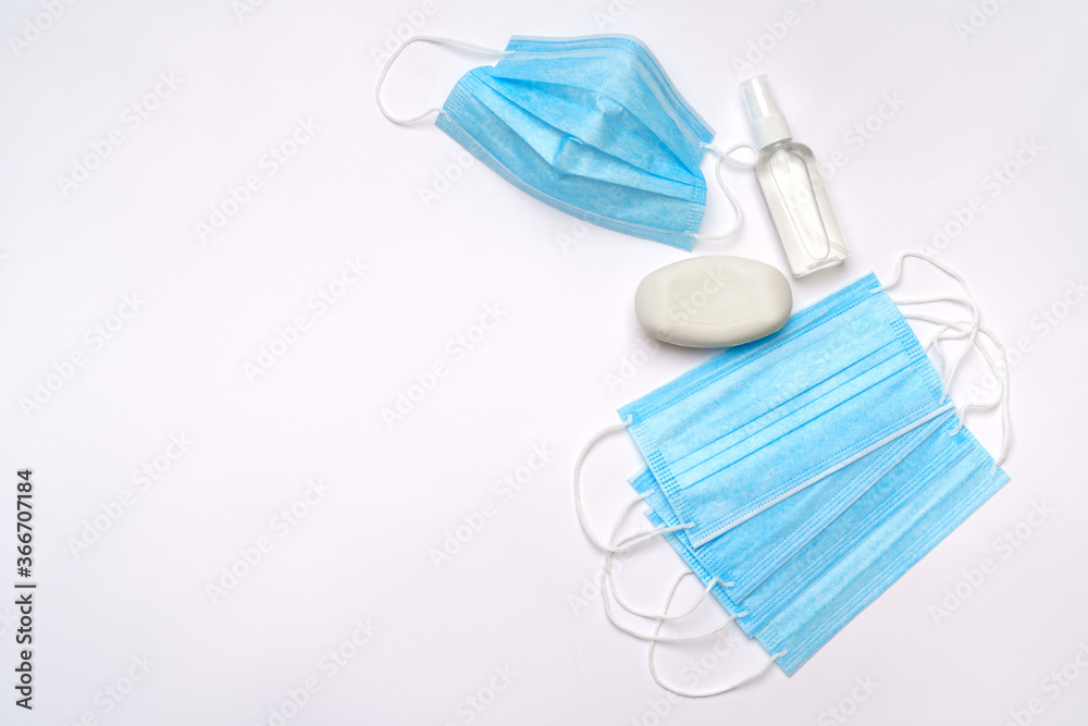 bottle of lotion, sanitizer or liquid soap and medical protective mask isolated on light grey background bottle of lotion, sanitizer or liquid soap and medical protective mask isolated on light grey background