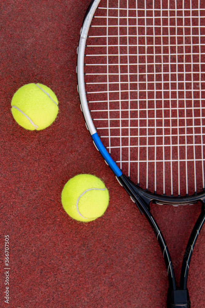 Close up. Tennis racket and balls on court.