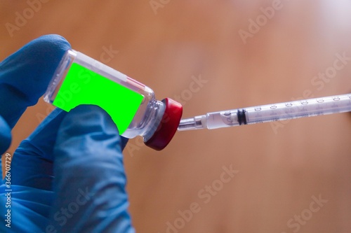 Concept of health cure with one hand in blue medical gloves with coronavirus, Covid virus19 photo