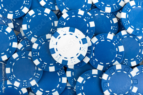 Battle White versus Blue yin vs yang Playing Poker Chips laying on the table mixed together. Abstract Pattern Background 