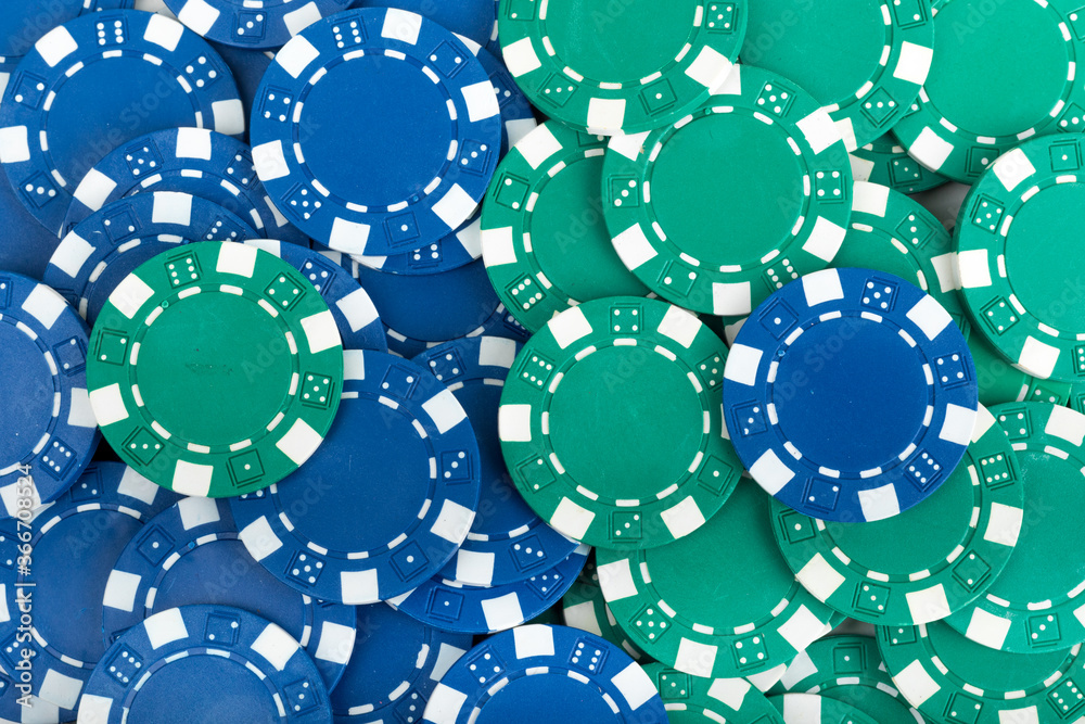 Battle Blue versus Green yin vs yang Playing Poker Chips laying on the table mixed together. Abstract Pattern Background Battle Blue versus Green yin vs yang Playing Poker Chips laying on the table mixed together. Abstract Pattern Background