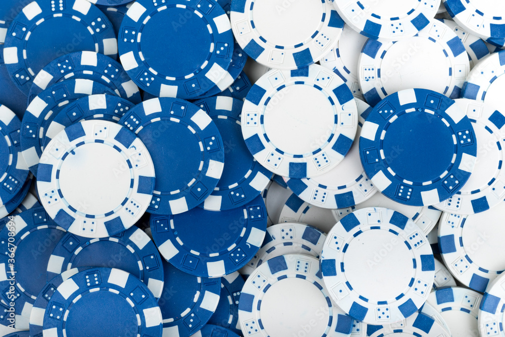 Battle Blue versus White yin vs yang Playing Poker Chips laying on the table mixed together. Abstract Pattern Background