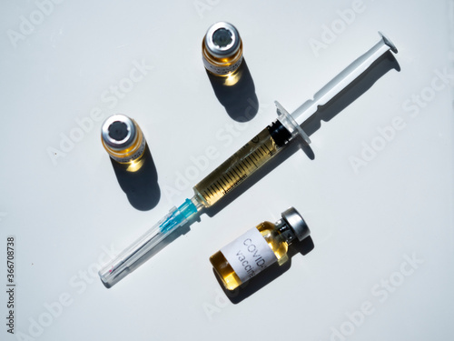 In this photo illustration, vials labelled as Coronavirus vaccine and a syringe seen displayed as the world anxiously awaits for the vaccine against coronavirus.